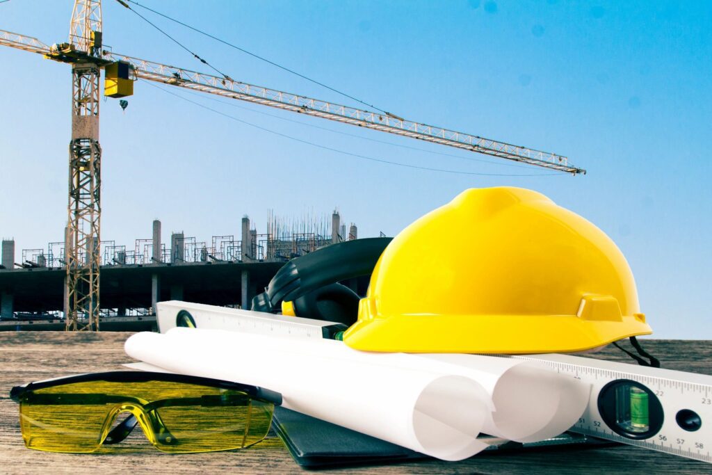 A construction site with some yellow hard hats and white pipes